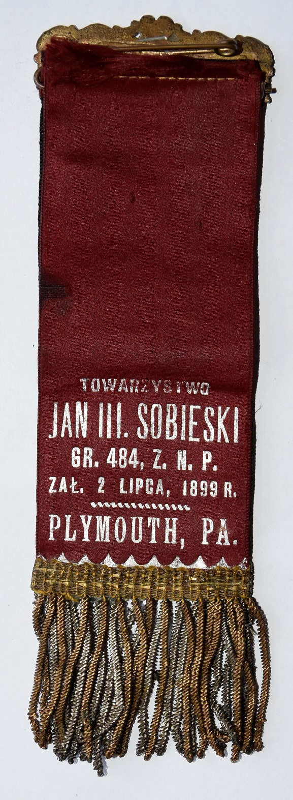 Rewers szarfy Towarzystwa im. Jana III Sobieskiego. Na materiale w kształcie wstążki zakończonej na dole frędzlami, napis: Towarzystwo Jan III Sobieski, gr. 484, Z. Z. N. P. zał. 2 lipca, 1899 r.